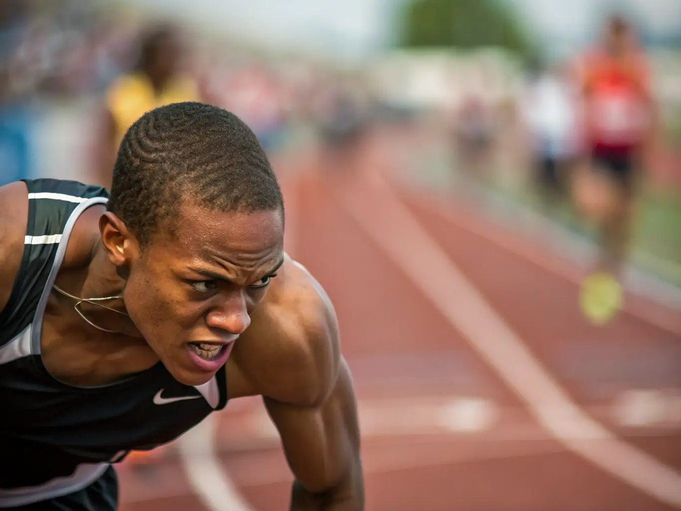 A dynamic image of individuals participating in a track and field event, highlighting speed, agility, and individual performance.