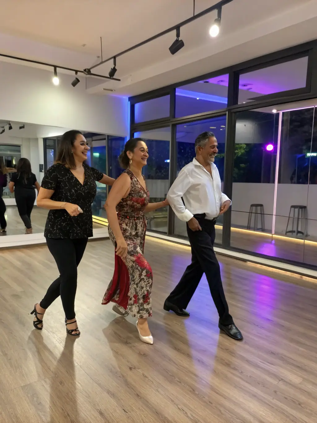 A diverse group of adults enjoying a beginner jazz dance class, learning basic steps and having fun at Danse Attitude Pontchâteau.